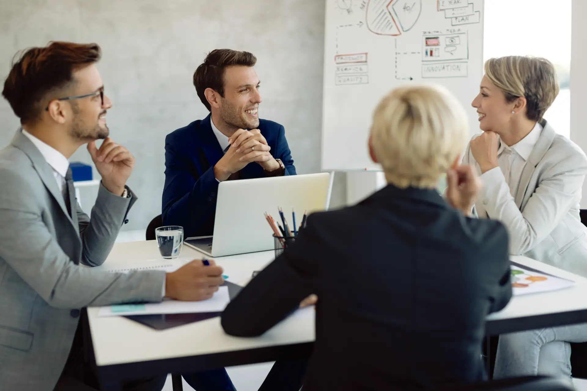 happy-business-team-communicating-meeting-office